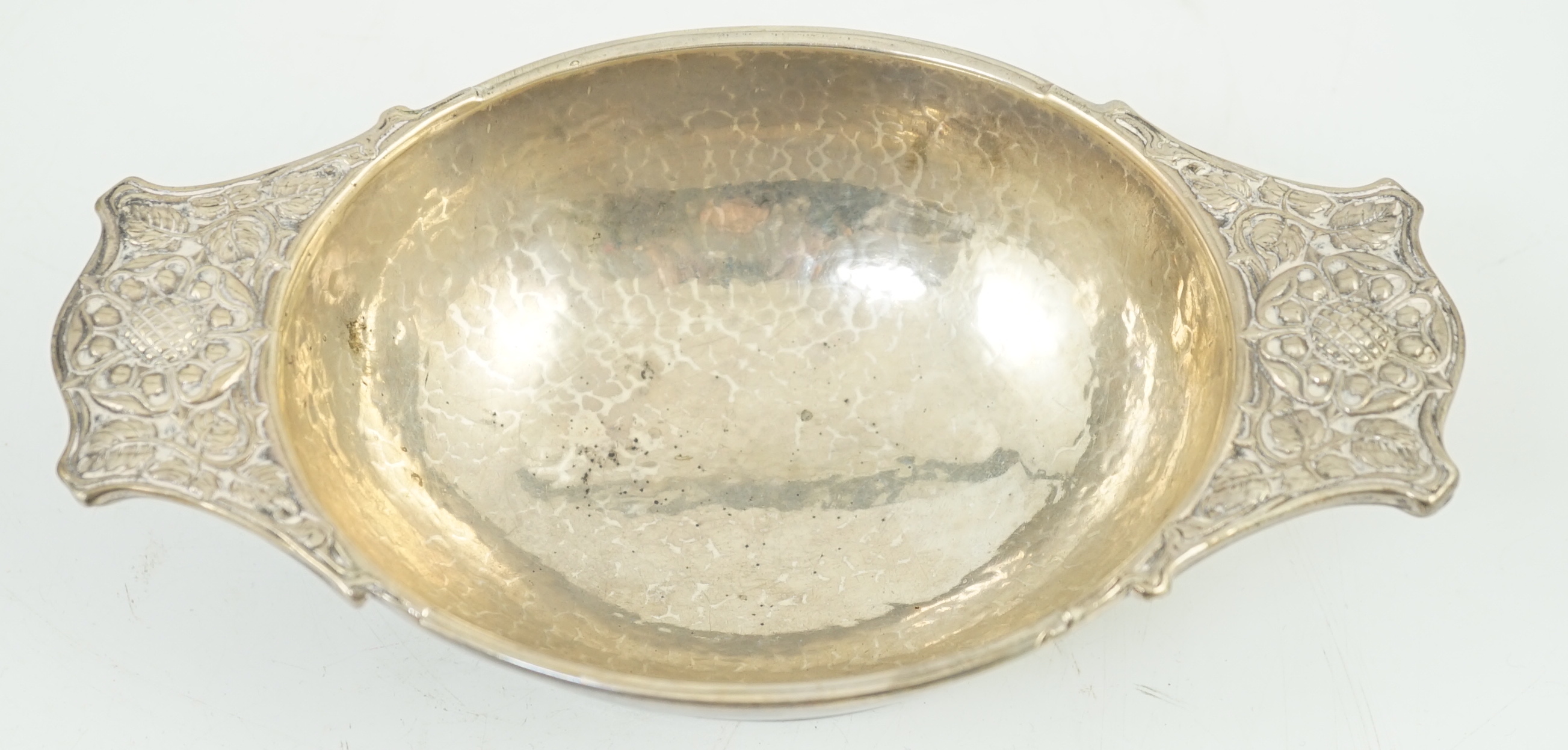 A George V Arts & Crafts planished silver two handled oval bowl by Omar Ramsden